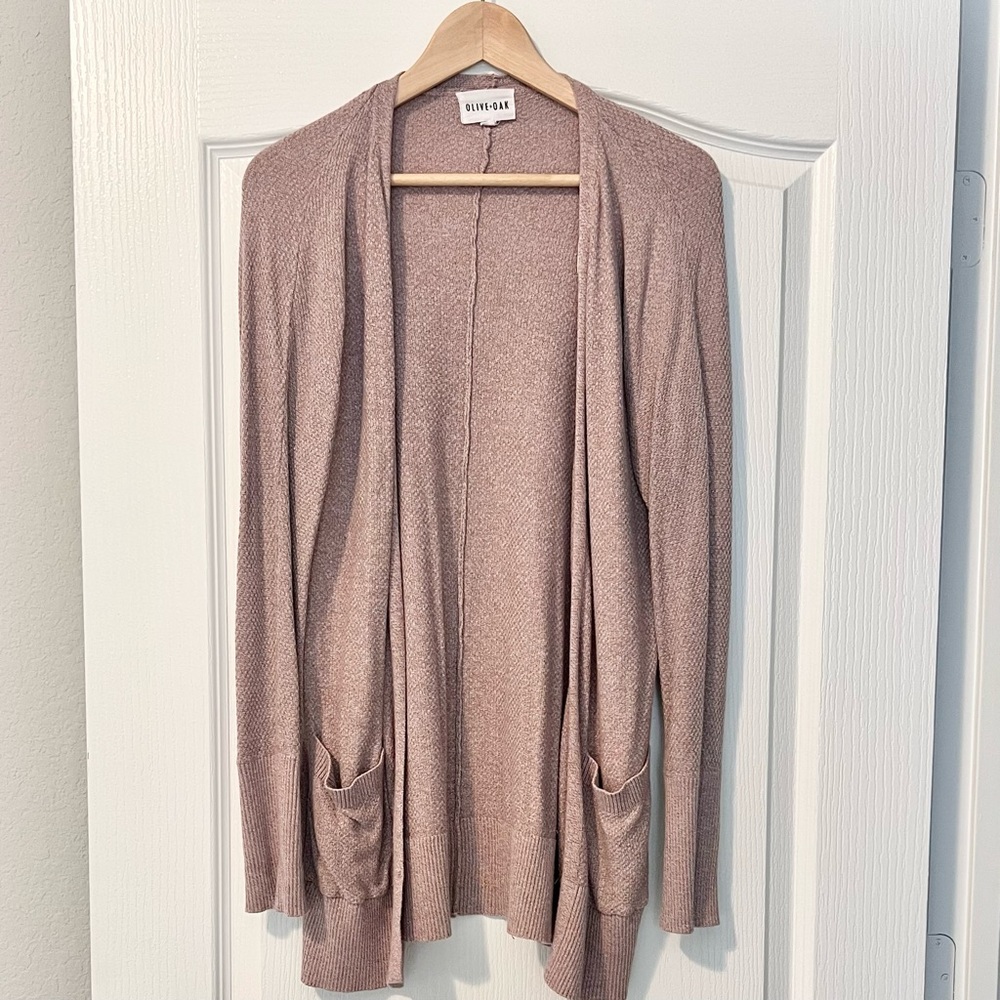 Long, blush pink cardigan. Lace up detail on side. Front pockets.